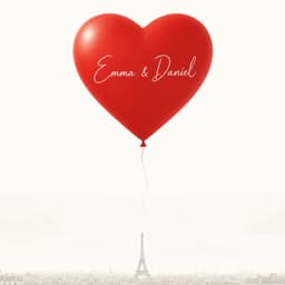 A red heart helium balloon engraved with two names, floating above the Paris rooftops
