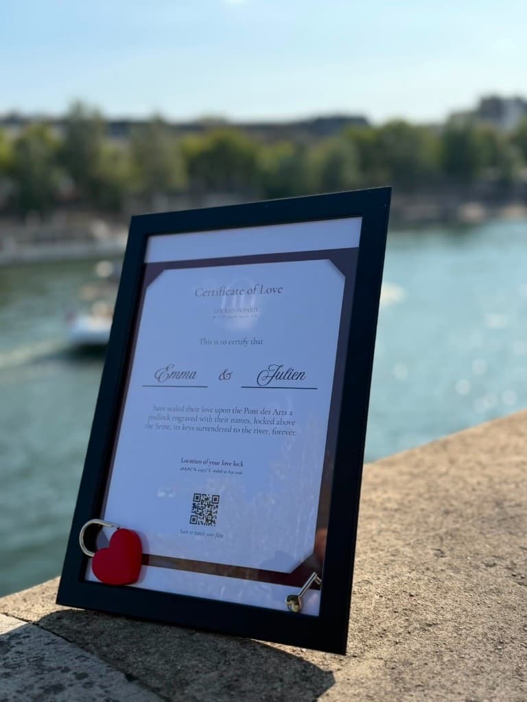Your framed Certificate of Love, with the padlock and its key, in front of the Seine